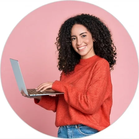 Smiling woman in a red sweater working on a laptop